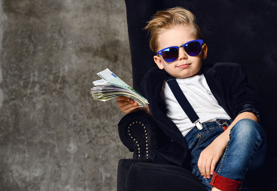rich kid millionaire sits with a bundle of money